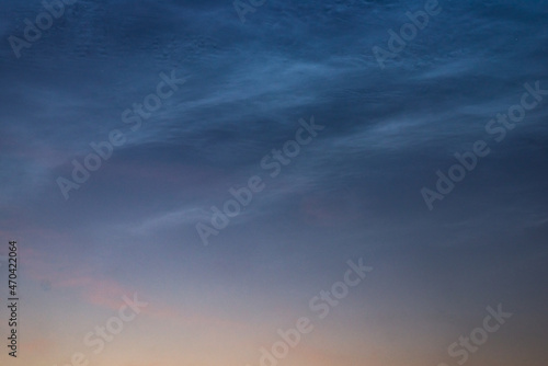 Noctilucent clouds close up on a summer night. Glowing clouds in the night sky.