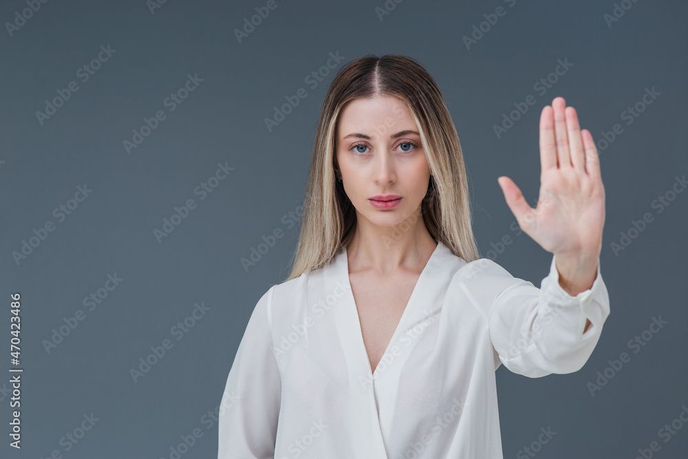 Beautiful blonde woman gesture and sign concept. She raised her hands and expressing stop the harassment abuse concept. Includes copy space. Beautiful blonde woman gesture and sign concept. She raised her hands and expressing stop the harassment abuse concept. Includes copy space.