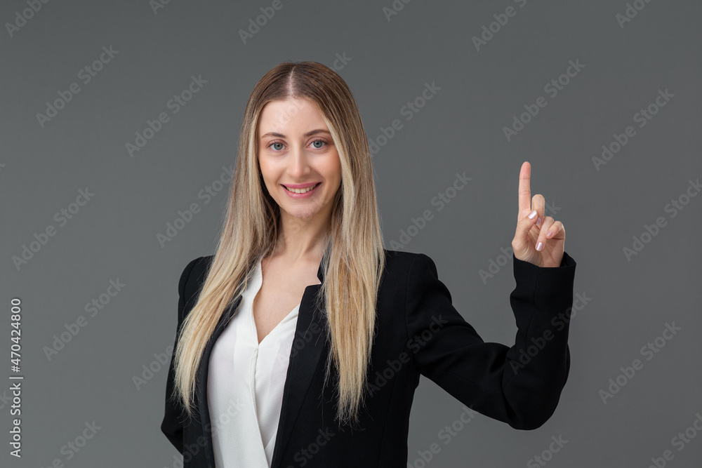 Beautiful blonde business woman portrait, she is pointing the up for adverstiesement purposed or idea concept.Includes copy space. Beautiful blonde business woman portrait, she is pointing the up for adverstiesement purposed or idea concept.Includes copy space.