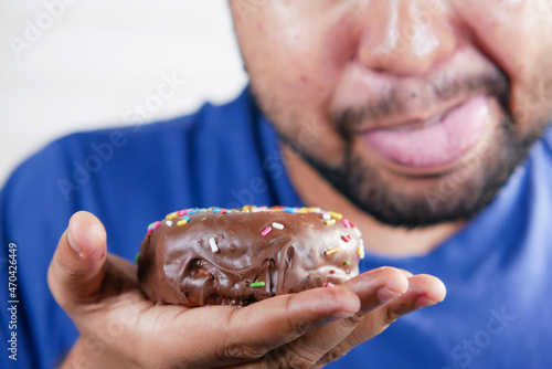  young man eating donut , selective focus  © Towfiqu Barbhuiya 