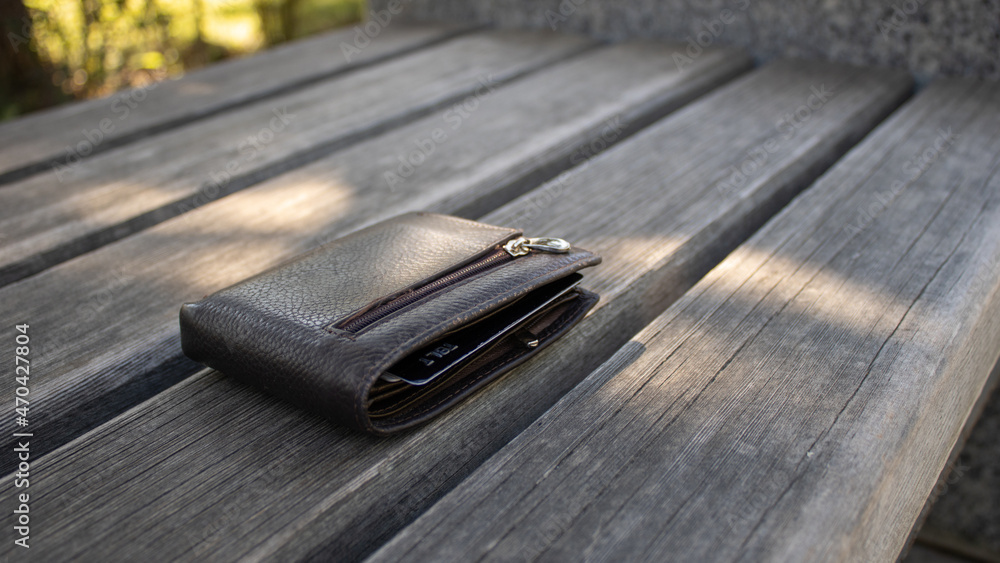 A leather money wallet left on a park bench. Lost thing. A leather money wallet left on a park bench. Lost thing.