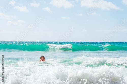 Boy playing in sea, head shot, Alvor, Algarve, Portugal, Europe