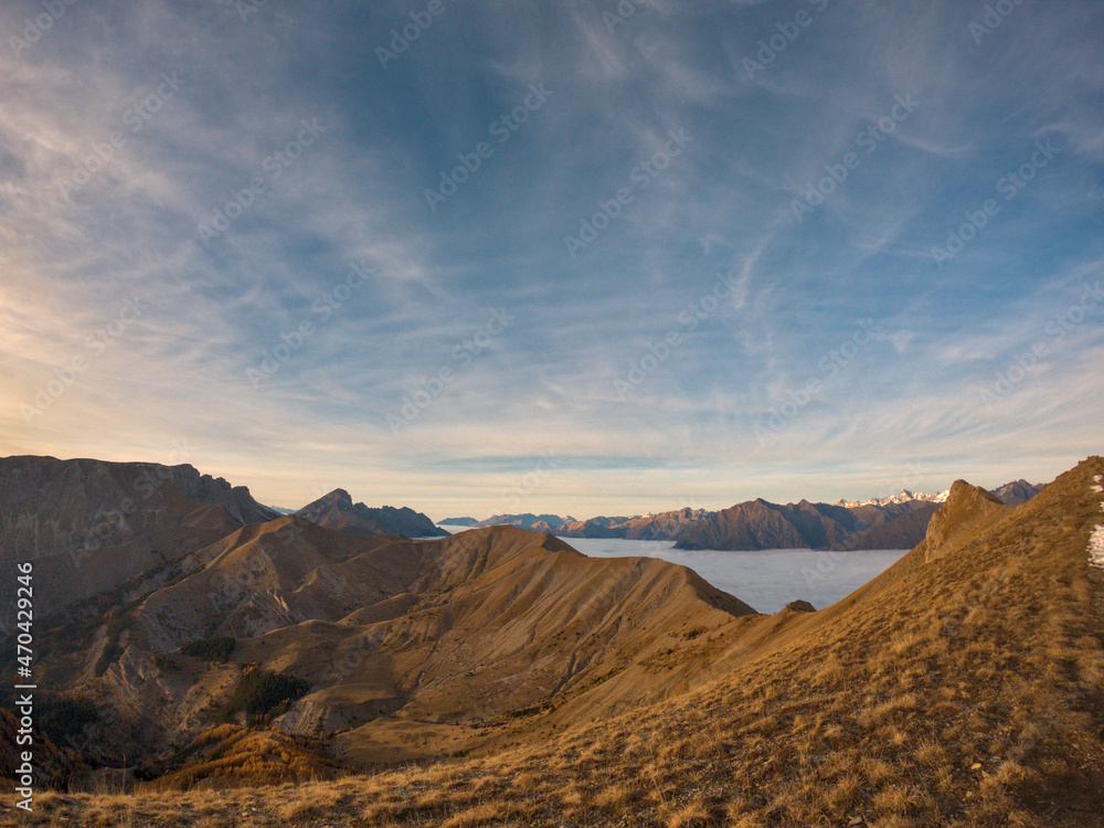 Fototapeta premium light sunset with a cloud of sea shot during a hike in peak of Gleize, Champsaur, french alps