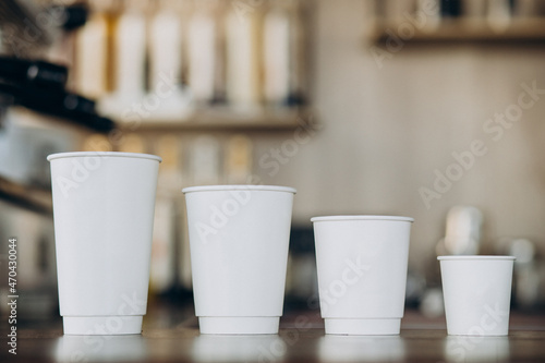 Cardboard coffee cups on table in a coffee shop