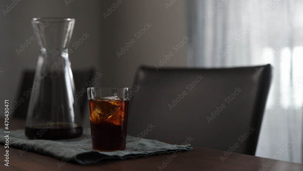 fresh coffee with ice rock in tumbler glass on wood table