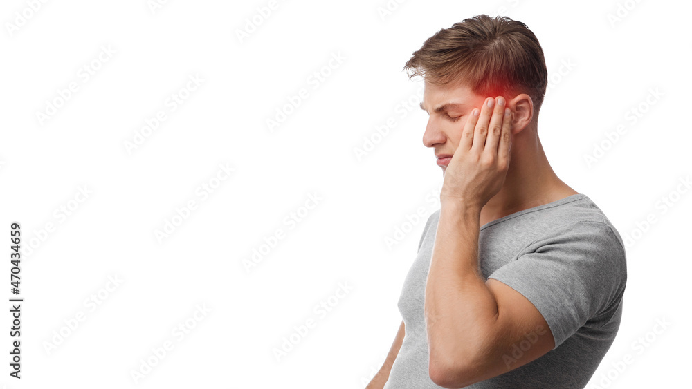 Unhappy young caucasian man suffering from headache, touches his forehead, highlighted in red Unhappy young caucasian man suffering from headache, touches his forehead, highlighted in red