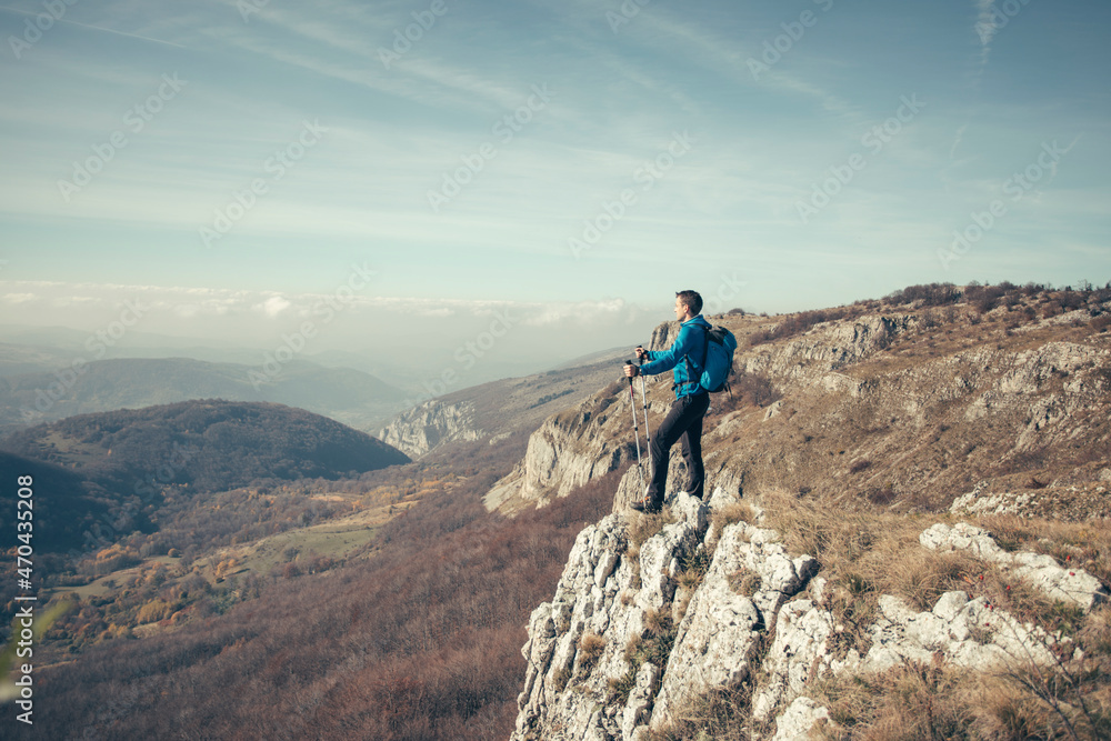 Hiker man at mountain viewpoint
