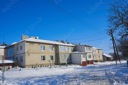 apartment house in winter,old soviet brick house in winter in the city, two-storey house in the snow