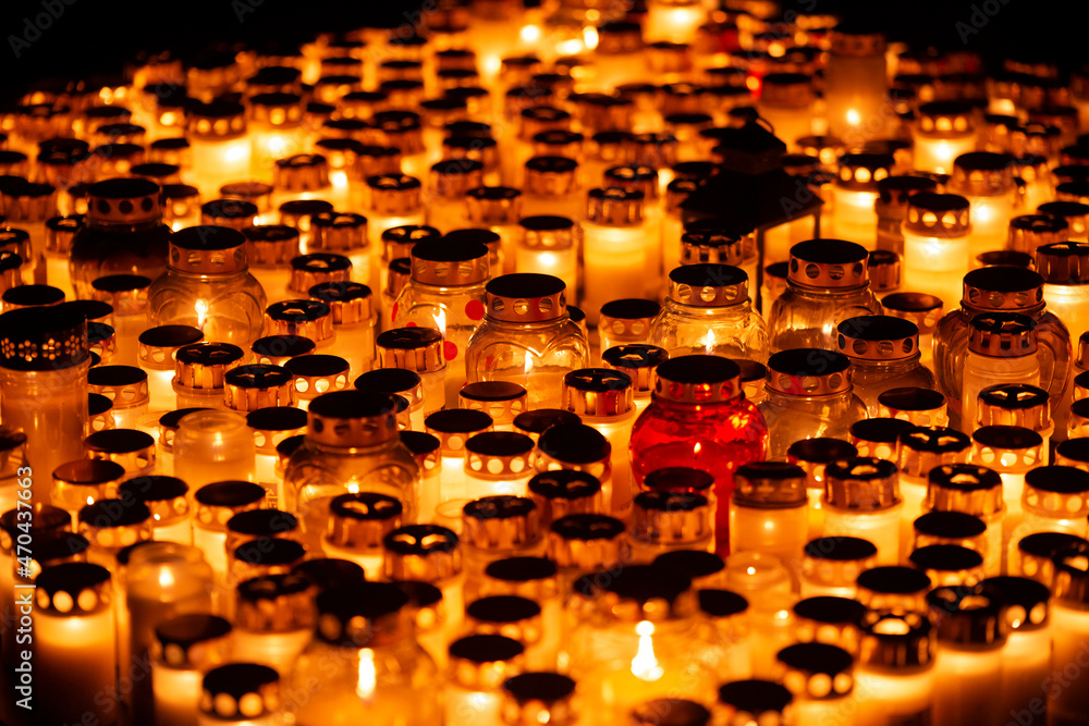 Hundreds of lit candles in jars