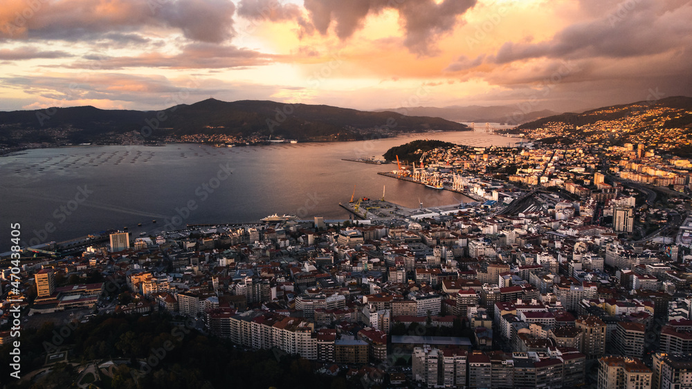 Aerial drone view of Vigo city of Galicia region north Spain with commercial harbour and famous bridge over the ocean during sunset 