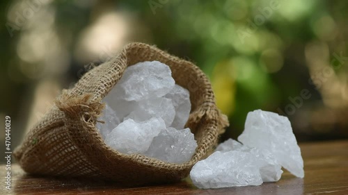 Alum in a coconut cup on nature background. photo