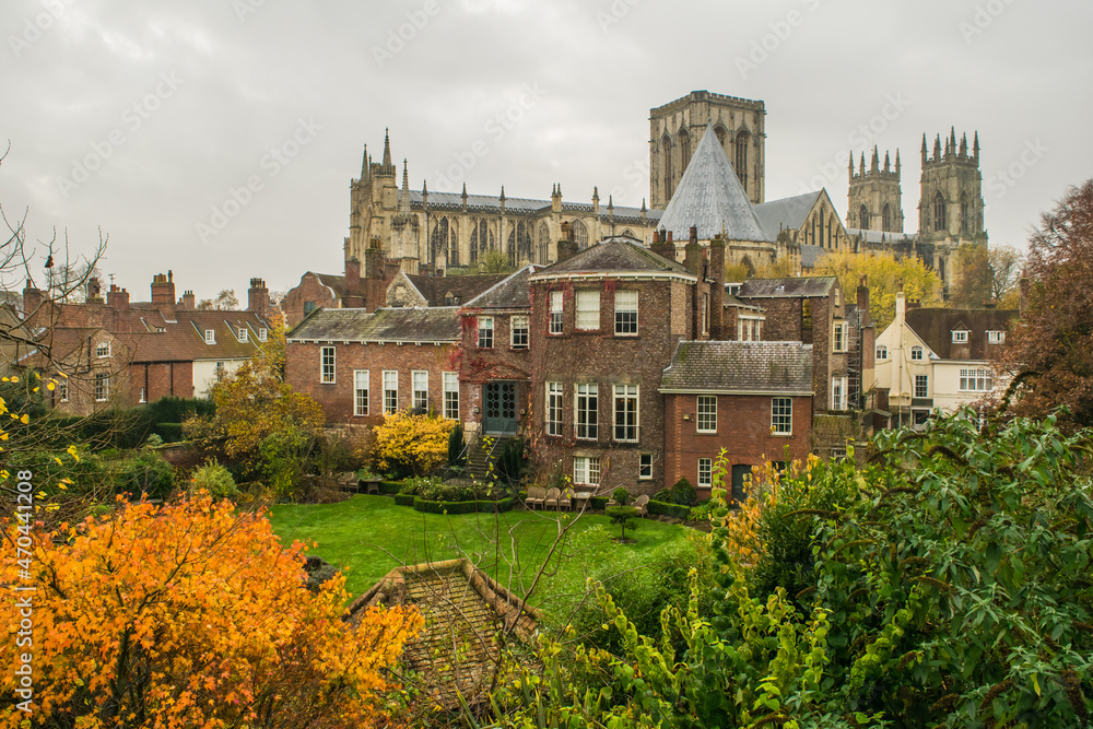 Colorful autumn gardens of british manor with view of York Minster in York England
