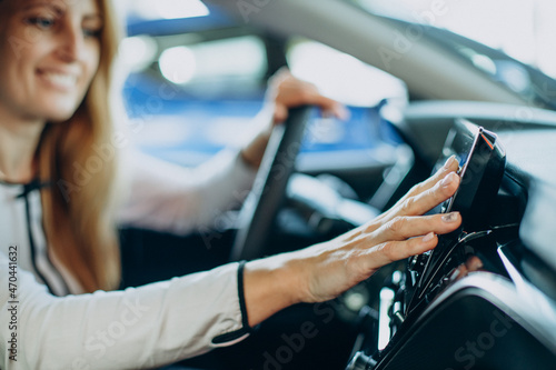 Woman touching screen in her car © Petro