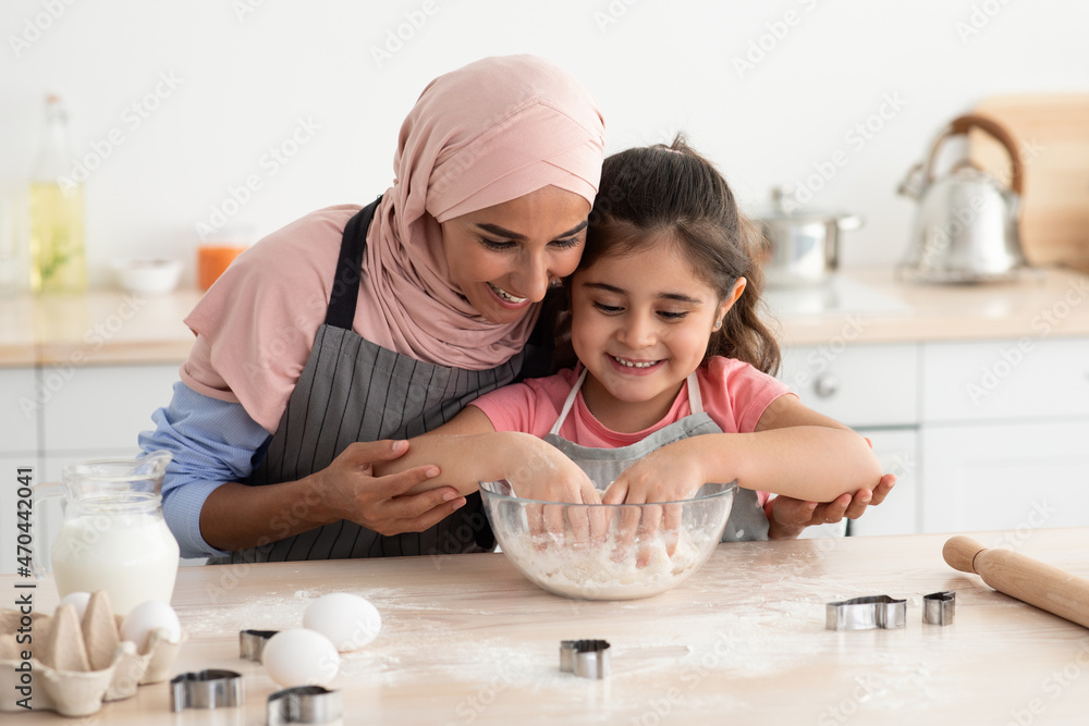 Cute Little Girl Baking In Kitchen With Her Muslim Mom Cute Little Girl Baking In Kitchen With Her Muslim Mom