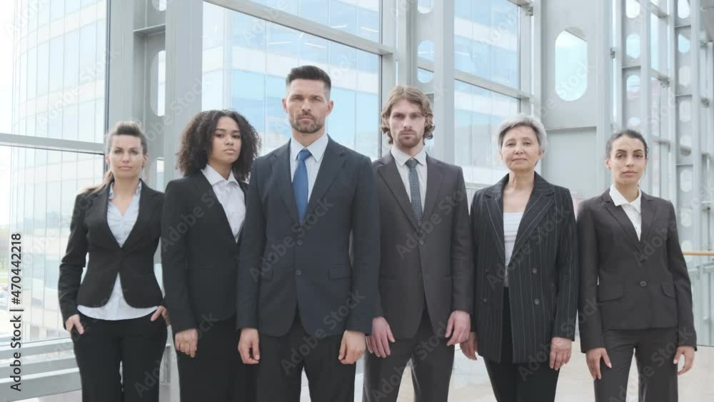 Multi ethnic group of confident business people in formal wear team indoors modern building full length portrait Multi ethnic group of confident business people in formal wear team indoors modern building full length portrait