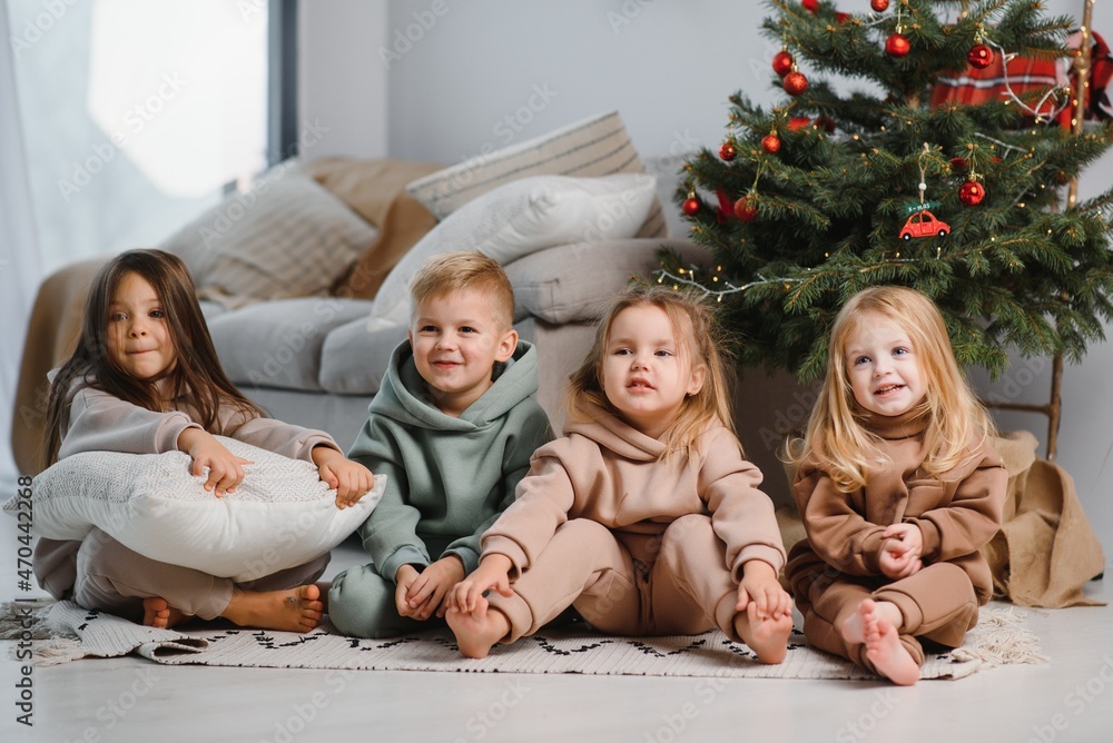 Group of four children with presents on Christmas party