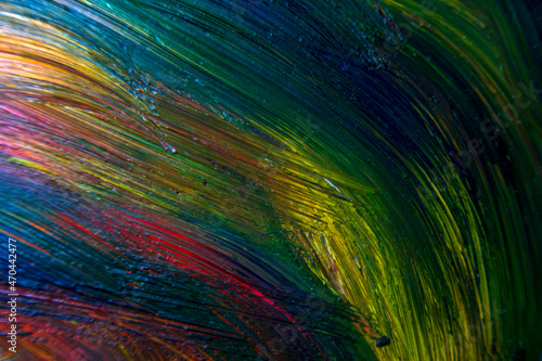 Colorful multicolored paint covered with water drops  theme wallpaper background. Selective focus. Multicolor abstraction. Abstract pattern close-up  texture liquid paint movement with water drops.