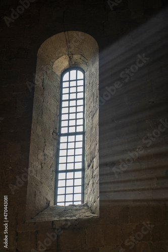 Sunlight penetrates through the arched window in the old orthodox cathedral , Georgia