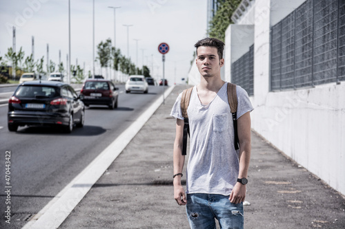 Attractive young man in city, walking, with white shirt