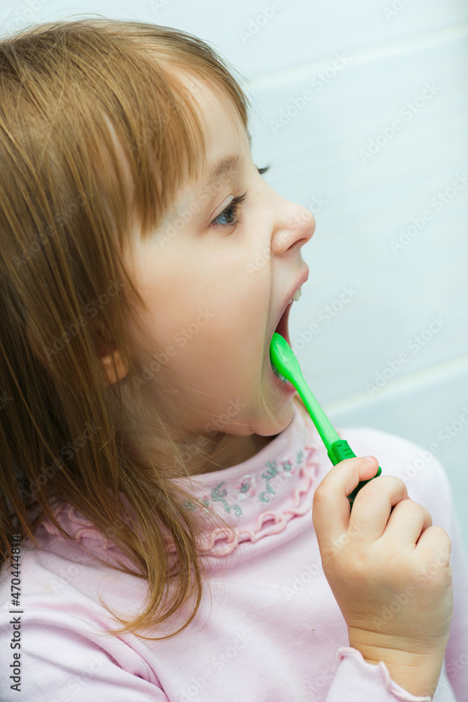 little girl holding a toothbrush and brushing her teeth thoroughly little girl holding a toothbrush and brushing her teeth thoroughly