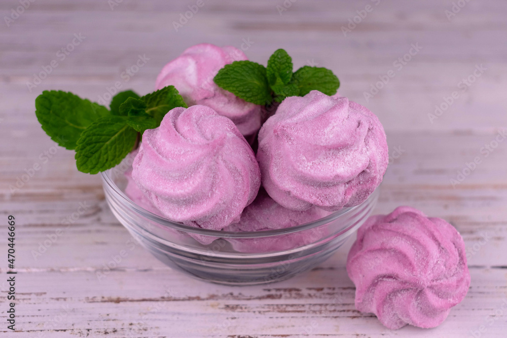 Pink marshmallows in a plate on a white background. Pink marshmallows in a plate on a white background.