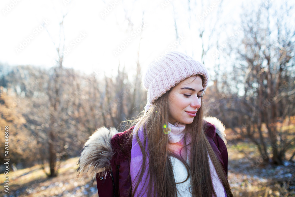 Beautiful young woman in a knitted hat walks in the park Beautiful young woman in a knitted hat walks in the park