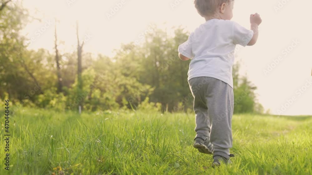 baby run the first steps. kid running in nature on the grass in park silhouette. happy family kid dream concept. people in the park. baby run, outdoor fitness forest. happy sunlight family catch-up baby run the first steps. kid running in nature on the grass in park silhouette. happy family kid dream concept. people in the park. baby run, outdoor fitness forest. happy sunlight family catch-up