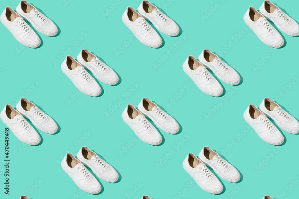 White sneakers pattern on background. The shoes are comfortable and casual. Background for a shoe store. White sneakers pattern on background. The shoes are comfortable and casual. Background for a shoe store.