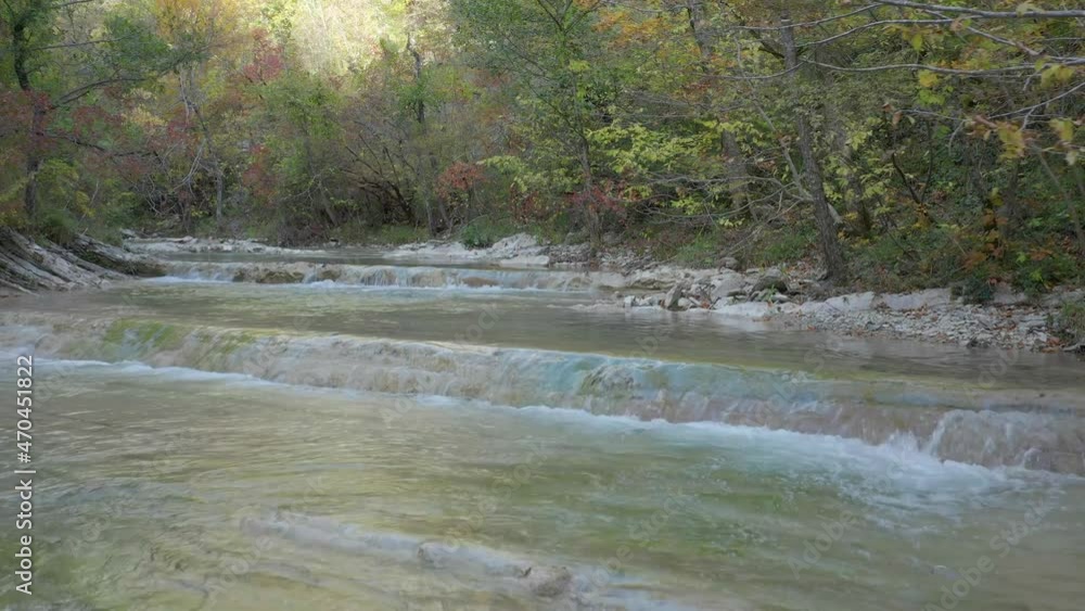 Drone flying upstream above rapid mountain river in autumn forest - Zhane river, Gelendzhik area, Caucasus, Russia Drone flying upstream above rapid mountain river in autumn forest - Zhane river, Gelendzhik area, Caucasus, Russia