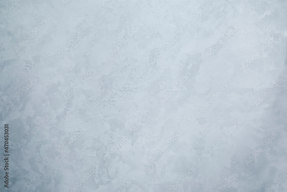 The texture of the wall with a monochrome pattern in the form of wet silk. Abstract background light gray
