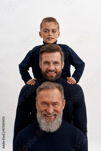Canvastavla Narrow portrait of three generations of men posing