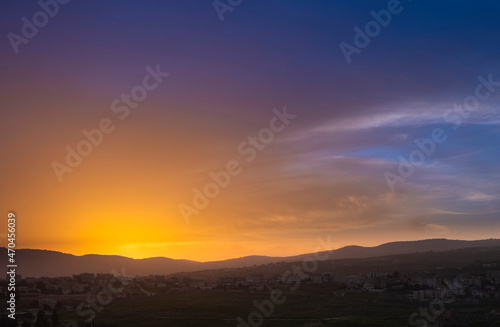 Colorful sunset sky over the city with hills. Jarash Jordan, © Lana Kray