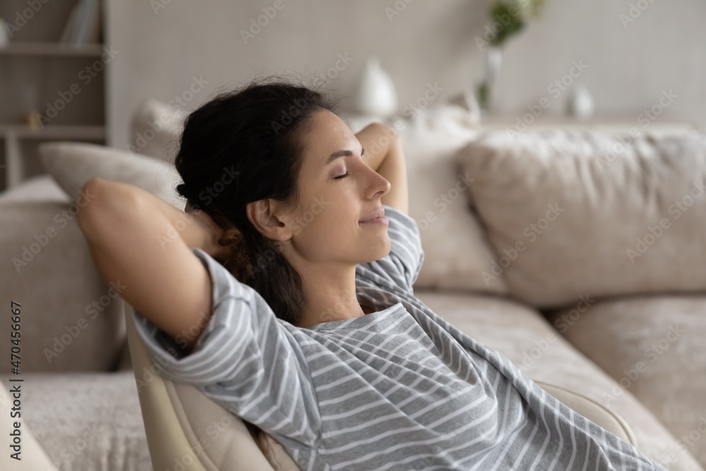 Close up peaceful woman with closed eyes and hands behind head relaxing in cozy chair alone, calm young female enjoying lazy leisure time at home, daydreaming, taking day nap or visualizing future Close up peaceful woman with closed eyes and hands behind head relaxing in cozy chair alone, calm young female enjoying lazy leisure time at home, daydreaming, taking day nap or visualizing future