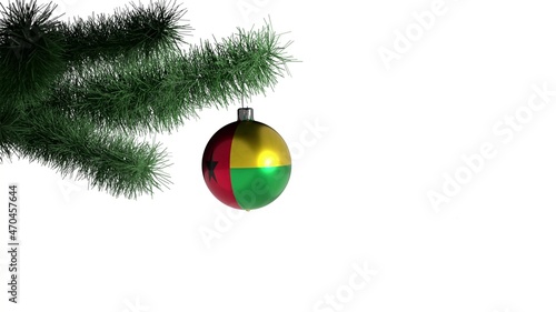 New Year ball with the flag of Guinea-Bissau on a Christmas tree branch isolated on white background. Christmas and New Year concept.