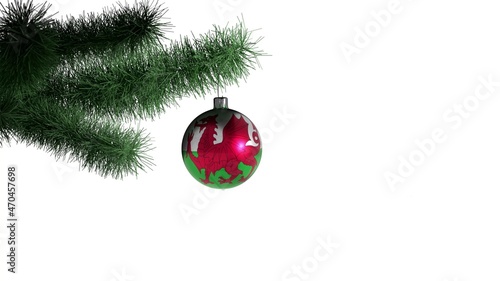 New Year ball with the flag of Wales on a Christmas tree branch isolated on white background. Christmas and New Year concept.