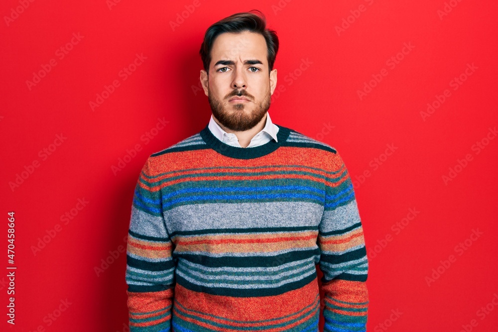 Handsome caucasian man with beard wearing elegant wool winter sweater depressed and worry for distress, crying angry and afraid. sad expression. Handsome caucasian man with beard wearing elegant wool winter sweater depressed and worry for distress, crying angry and afraid. sad expression.