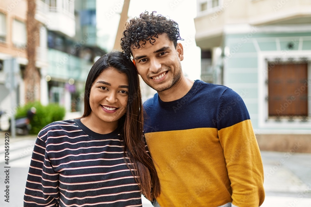 Young latin couple smiling happy and hugging at the city. Young latin couple smiling happy and hugging at the city.