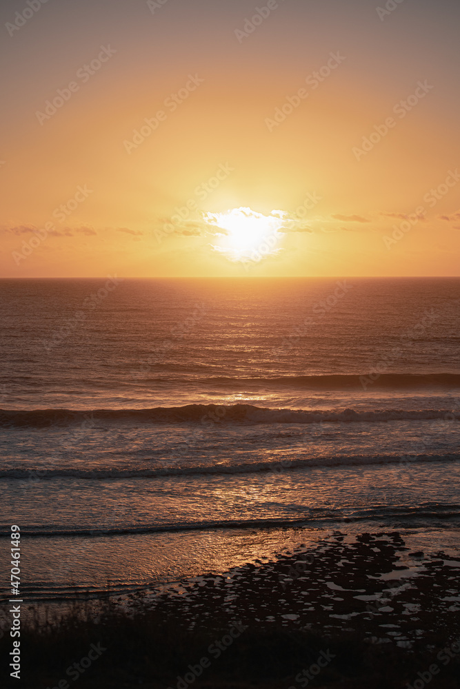 beautiful orange sunset over the blue sea with waves