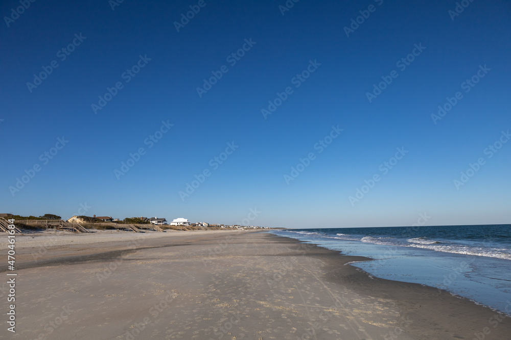 Empty Litchfield beach, South Carolina. Housing and visible people in far distance