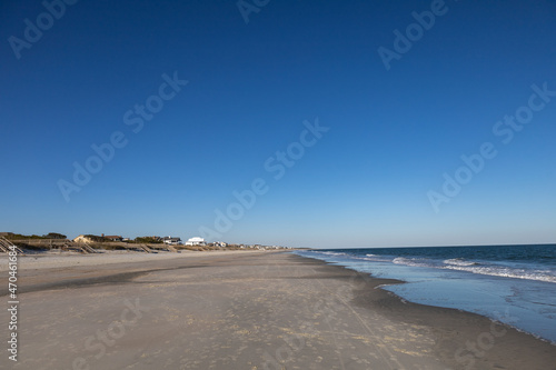 Empty Litchfield beach  South Carolina. Housing and visible people in far distance