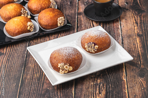 Bombolone or bomboloni is an Italian filled donut and snack food. German donuts - krapfen or berliner - filled with jam and chocolate photo