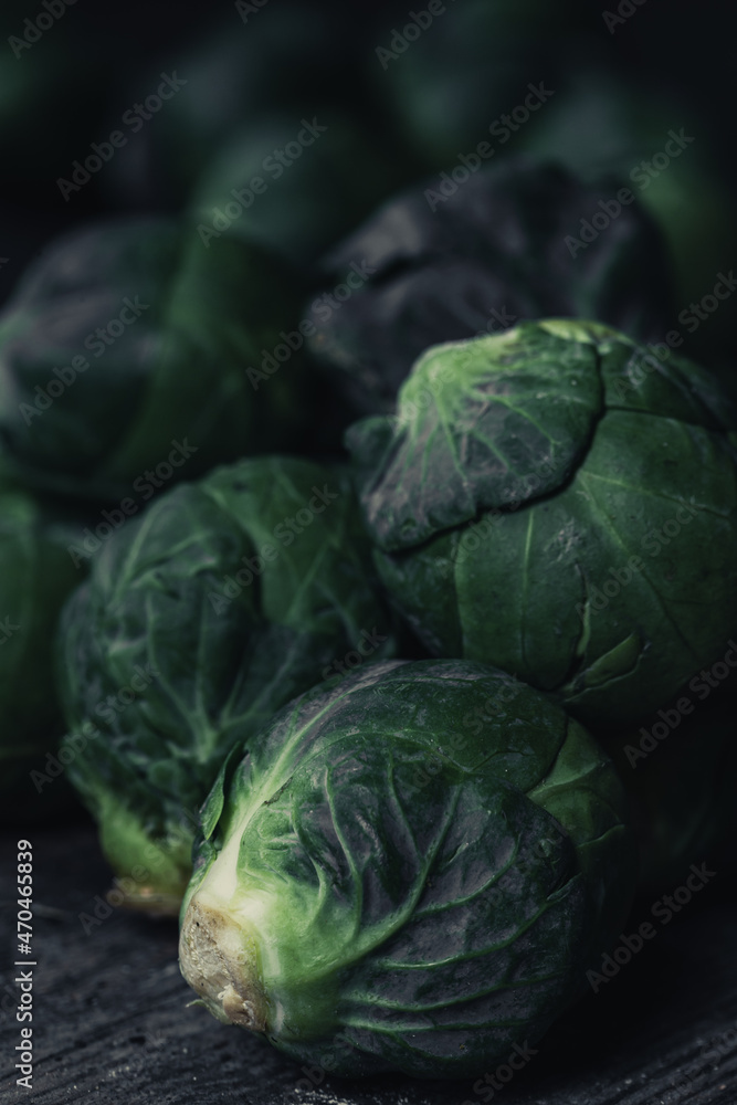 Brussels sprouts cabbage on old wooden table.Dark mood food photography. Brussels sprouts cabbage on old wooden table.Dark mood food photography.
