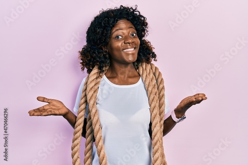Young african american woman training with battle rope celebrating achievement with happy smile and winner expression with raised hand © Krakenimages.com