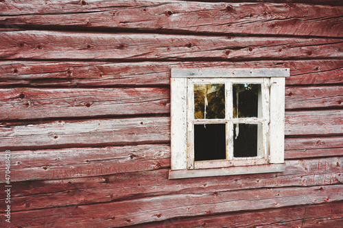 Window of abandoned log farmhouse at a summer farm up in the Totenåsen Hills, Norway.