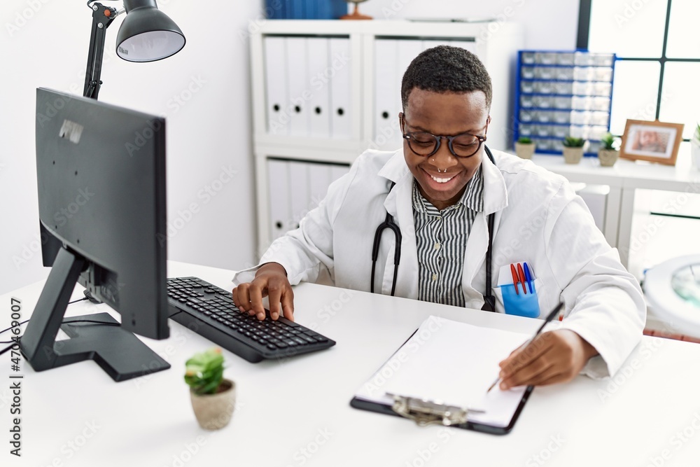 Young african man working as doctor at medical clinic Young african man working as doctor at medical clinic