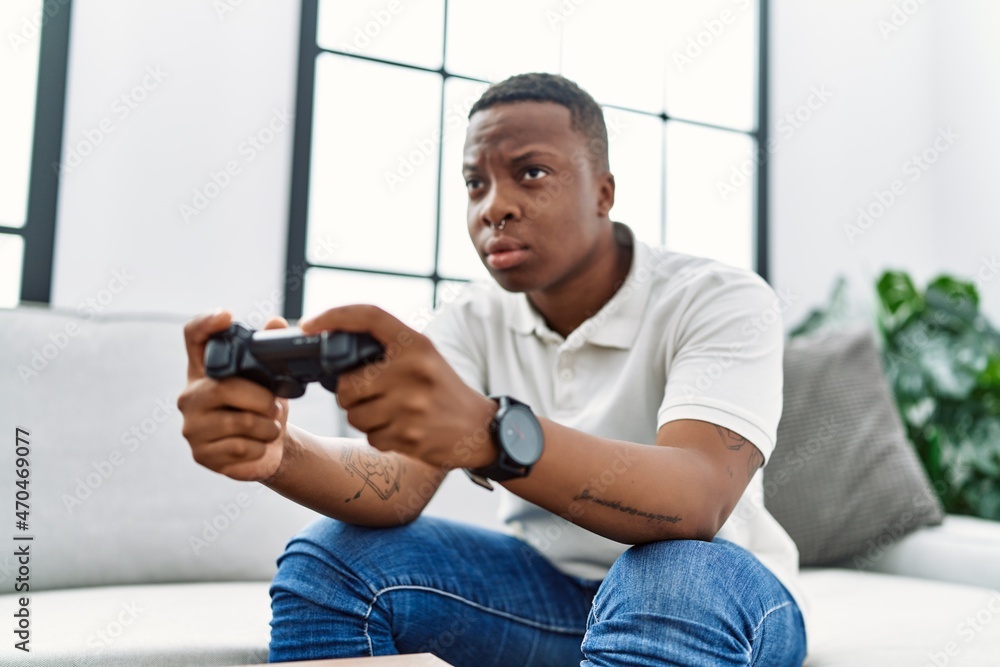 Young african man playing video games at home Young african man playing video games at home