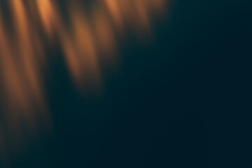 Blur light overlay. Defocused rays. Sun beam leak reflection. Bokeh gleam effect. Golden orange glow on dark black abstract background.