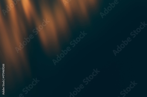 Blur light overlay. Defocused rays. Sun beam leak reflection. Bokeh gleam effect. Golden orange glow on dark black abstract background. photo
