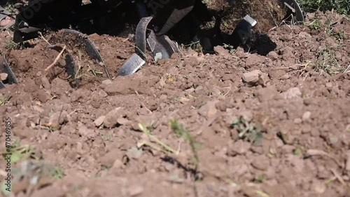 Farmer plows the land with a cultivator, Agricultural machinery mini tractor in the field