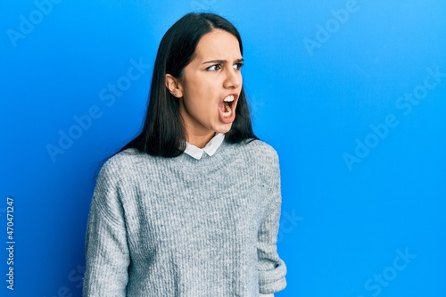 Young hispanic woman wearing casual clothes angry and mad screaming frustrated and furious, shouting with anger. rage and aggressive concept.